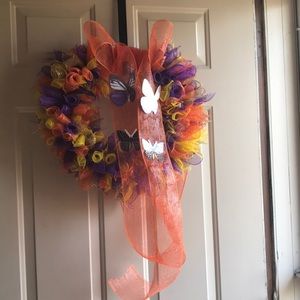 I’m selling a orange, purple and yellow wreath.